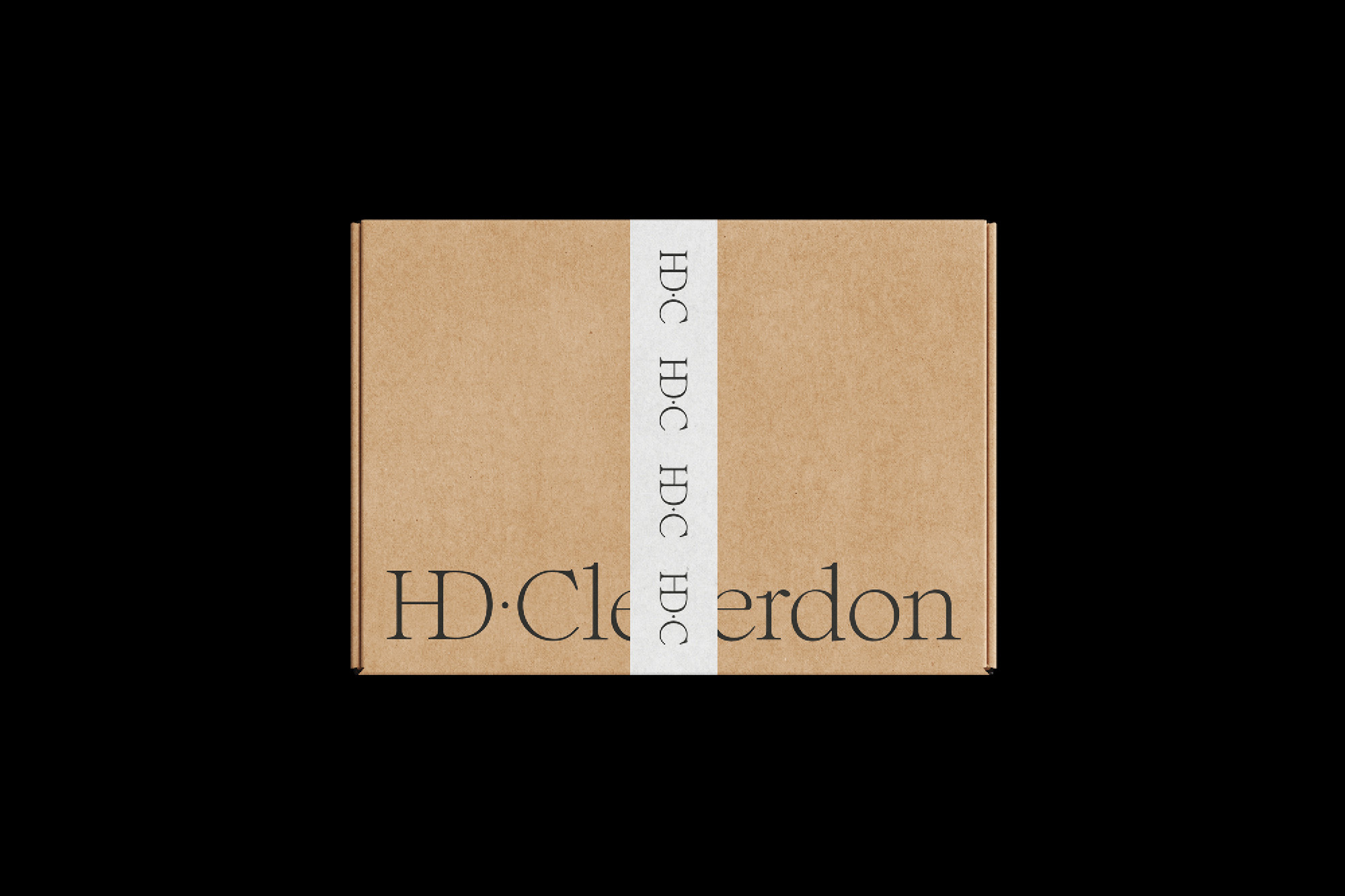 Cardboard shipping box with a white belly band and dark serif typography against a solid black background.