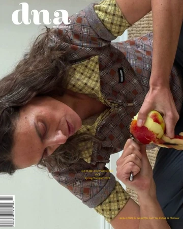 Magazine cover featuring a woman peeling a peach, showcasing fashion, food, and a close-up composition with clear brand visibility.