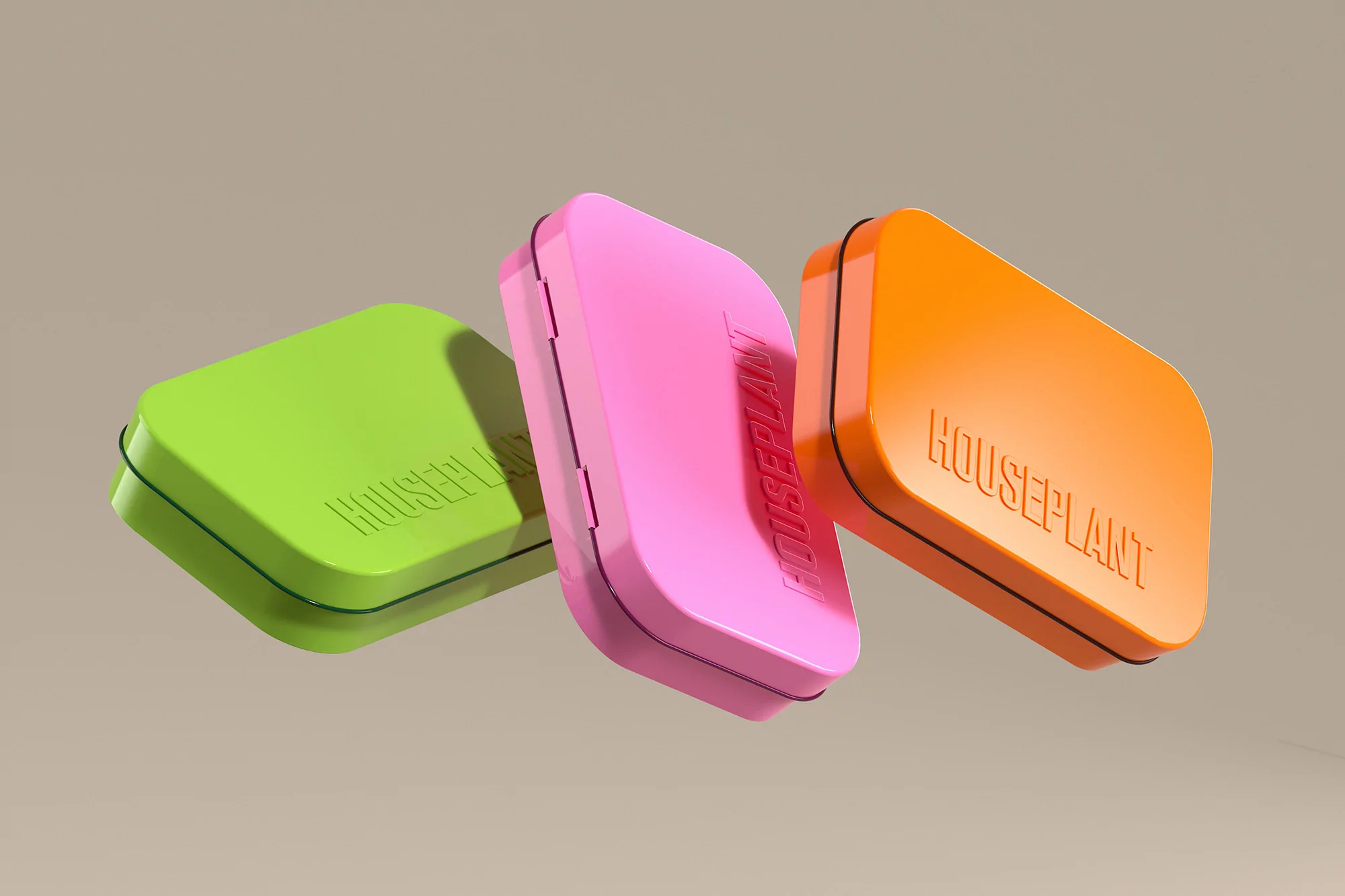 Three colorful metal boxes, green, pink, and orange, arranged diagonally on a neutral background, each with the word "HOUSEPLANT".