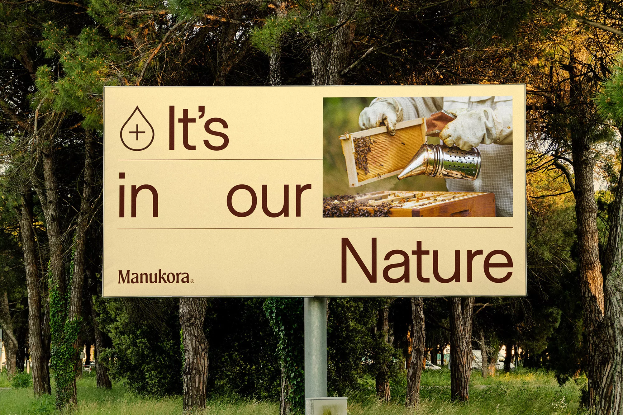 Outdoor billboard featuring an image of beekeepers and honeycombs in a forest, promoting a nature-related brand.