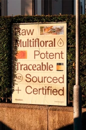 Manukora brand identity outdoor poster displaying bold typography and product photography mounted on a brick wall.