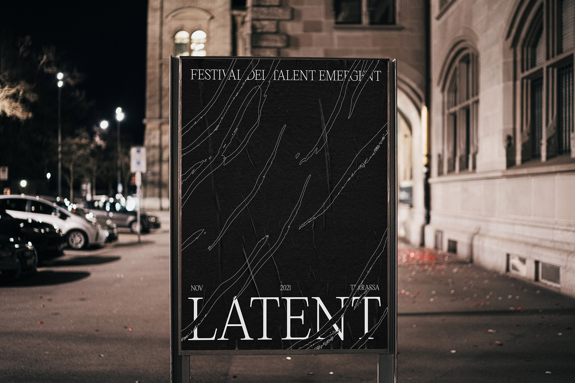 Outdoor advertisement on a city street at night showcases a black poster with abstract white lines and 'LATENT' in white font.