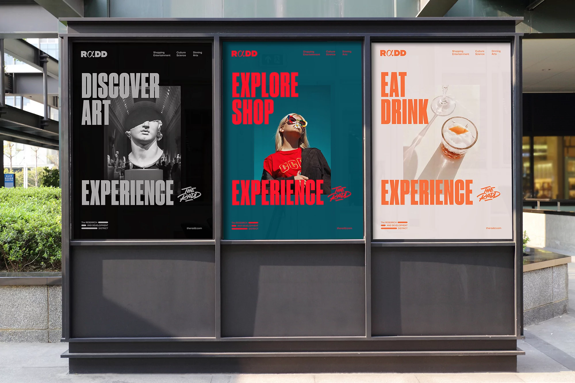Outdoor display of three large posters advertising 'ROADD': one with art, one with a woman, and one with a cocktail drink.