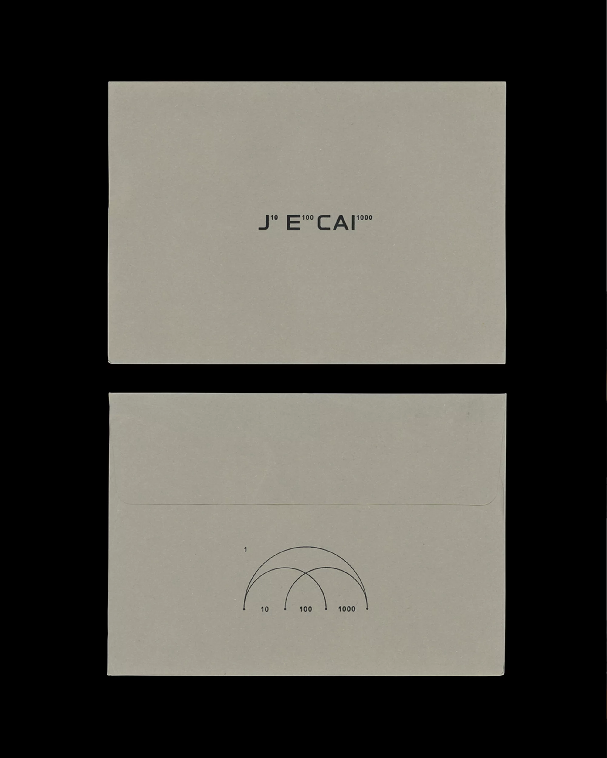 Minimalist shot of two stationery cards with geometric designs and text, set against a solid black background in a studio setting.