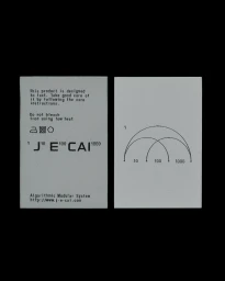 Two rectangular white paper tags featuring black typographic branding, care instructions, and linear diagrams against a black background.