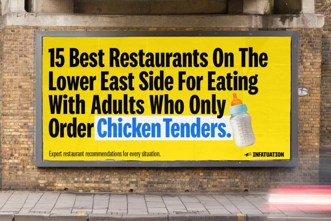 Outdoor billboard advertisement for restaurants in the Lower East Side, featuring humorous text and a baby bottle graphic on yellow background.