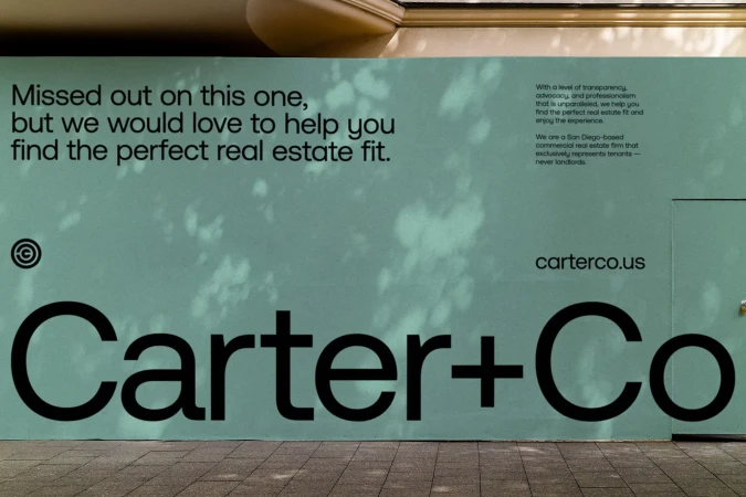Outdoor advertisement for Carter+Co, a San Diego-based commercial real estate firm specializing in tenant representation; company branding is displayed.