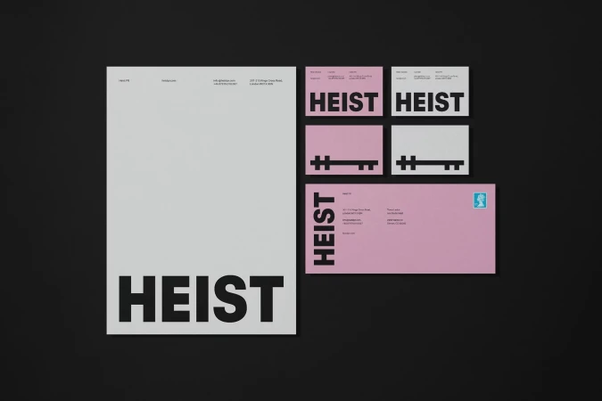 Promotional stationery set featuring a letterhead, business cards, and envelope with the word 'HEIST' in bold typography.