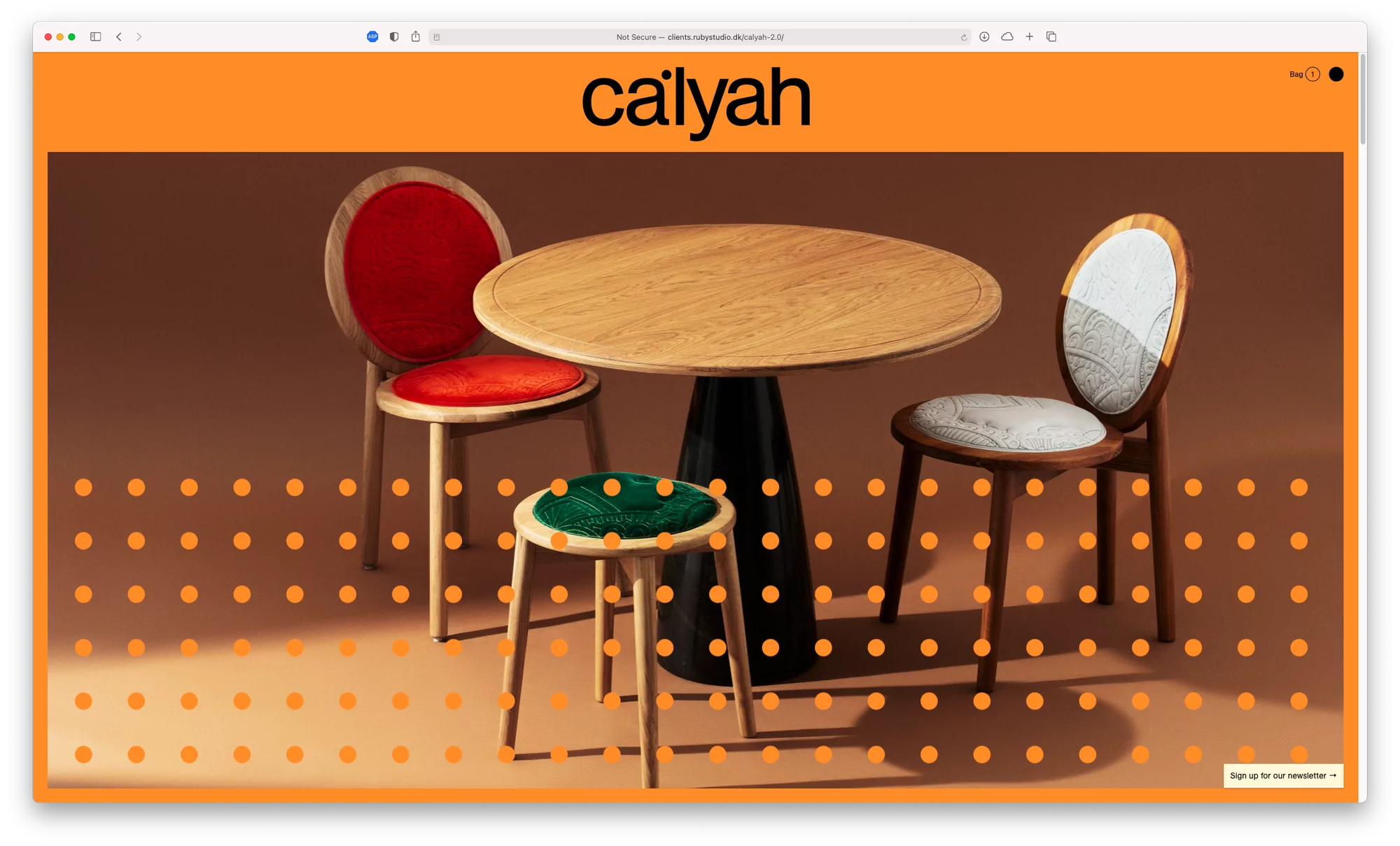 Calyah brand furniture, featuring a round wooden table with a black pedestal base, surrounded by three colorful chairs.