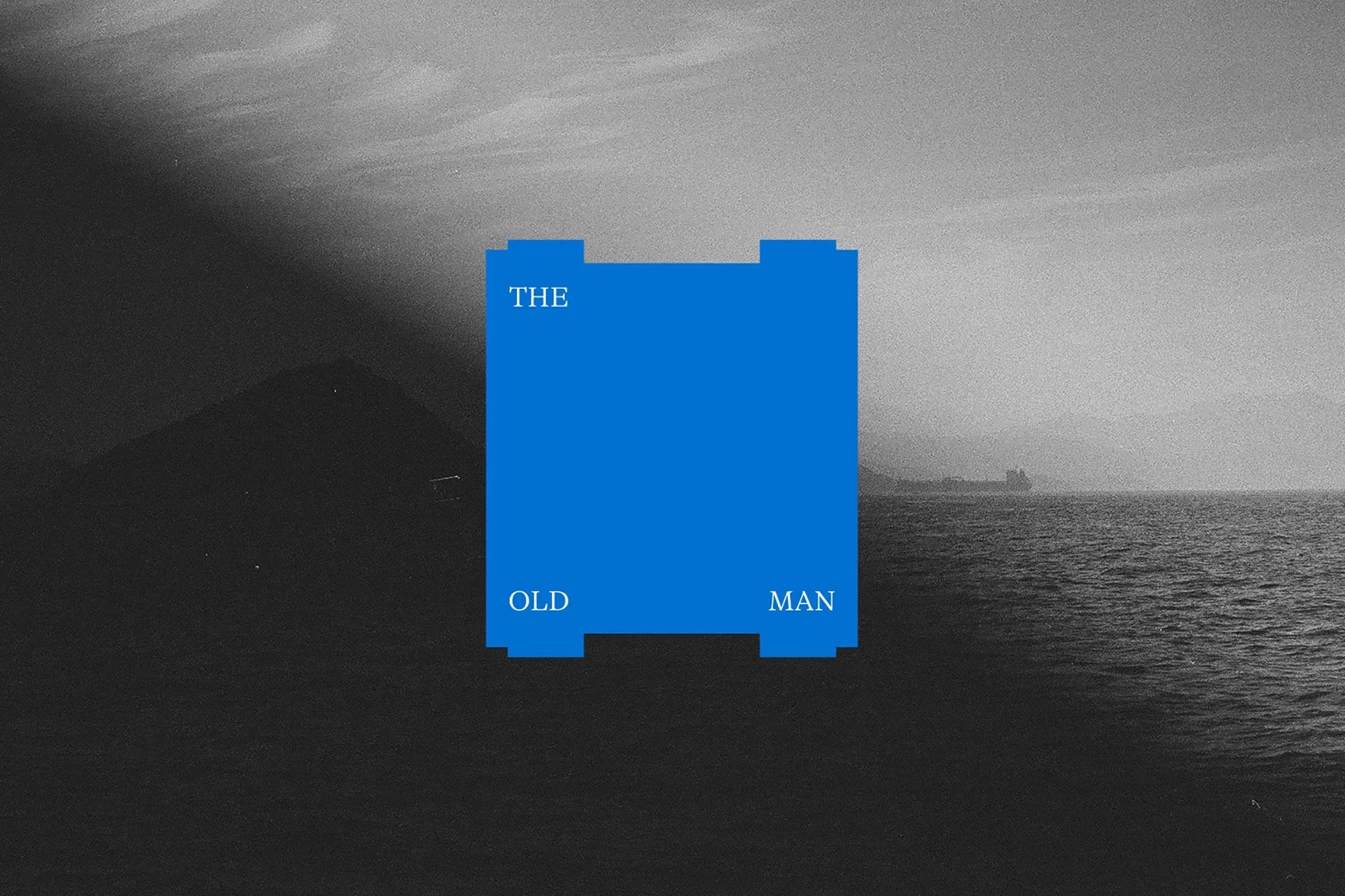 Black and white scenic landscape with a body of water, distant mountains, and a blue graphic with text that reads, 'The Old Man'.