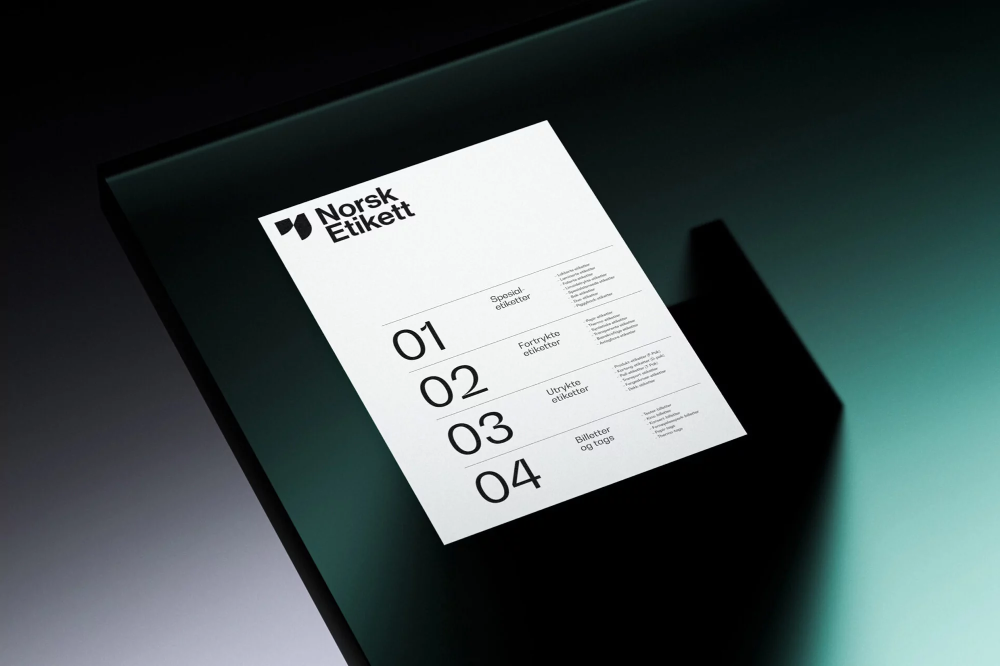 Flyer with 'Norsk Etikett' logo and a numbered list of services sits on a dark reflective surface, casting a shadow.