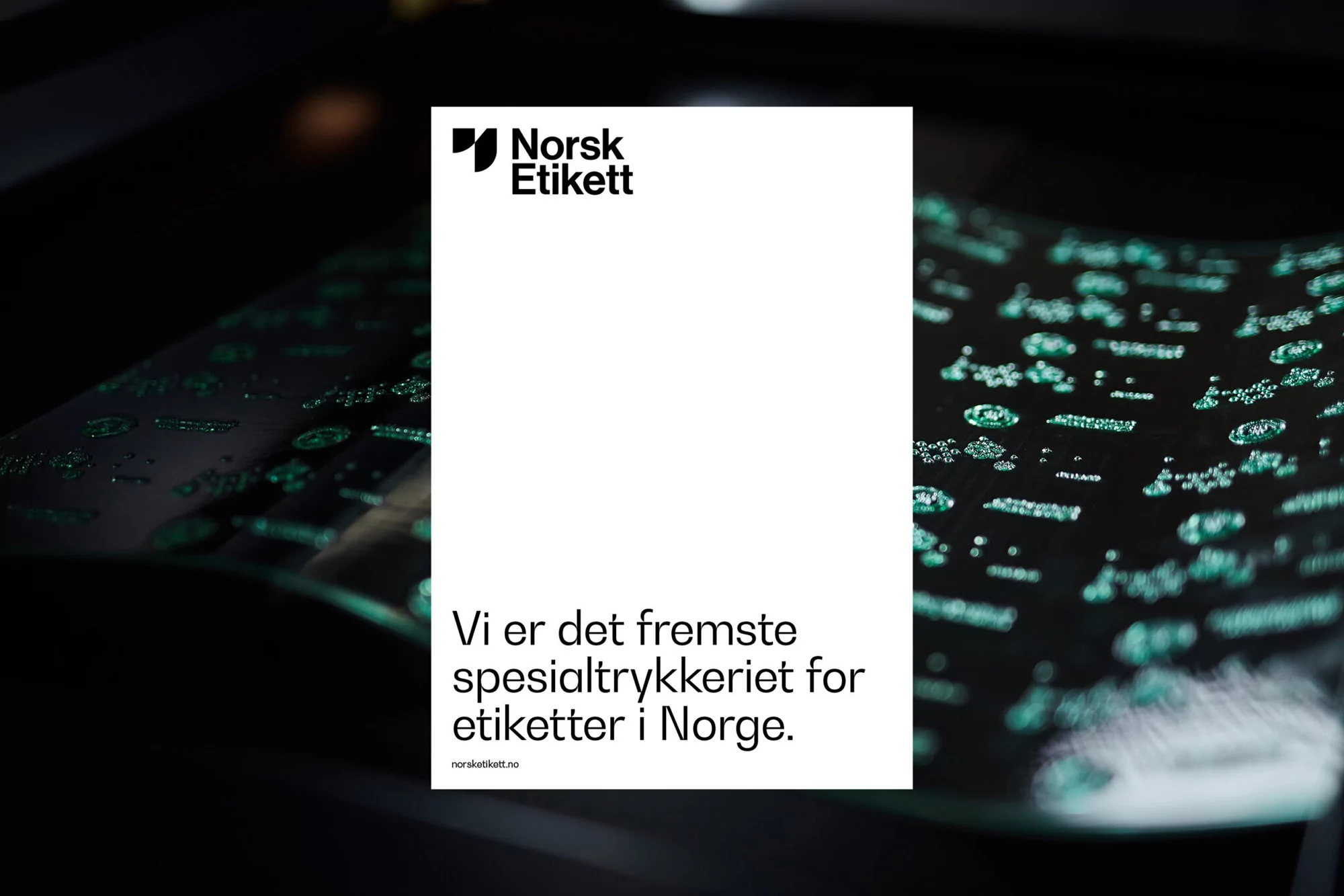 Promotional image features Norsk Etikett logo and text on a white paper, displayed against a blurred background of printed labels.