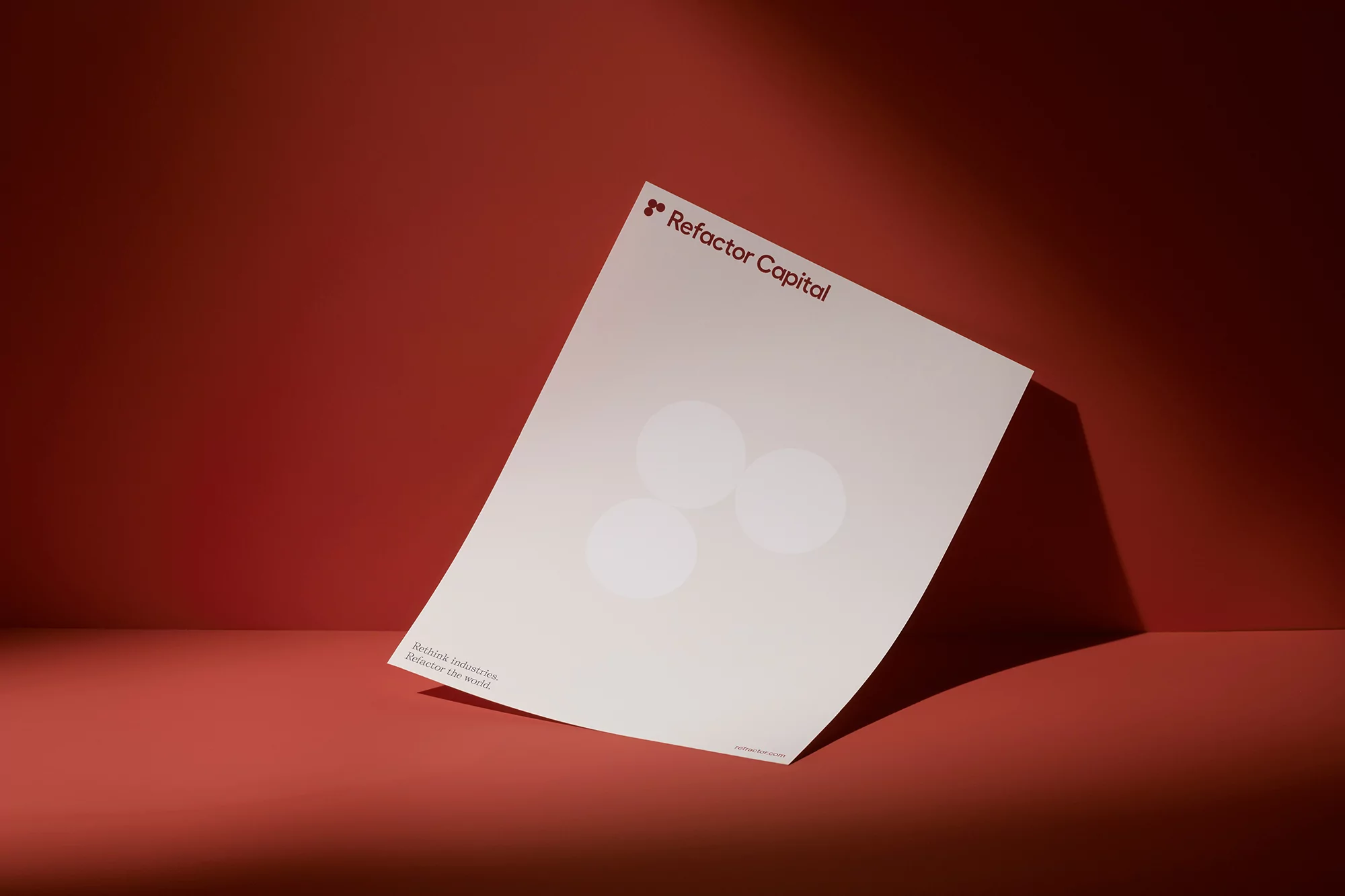 Promotional image for Refactor Capital featuring an off-white paper with the company logo set against a solid coral backdrop.