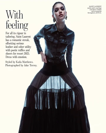 Model wearing a black leather jacket and long sheer skirt against a plain white background in a Vogue Australia fashion editorial.