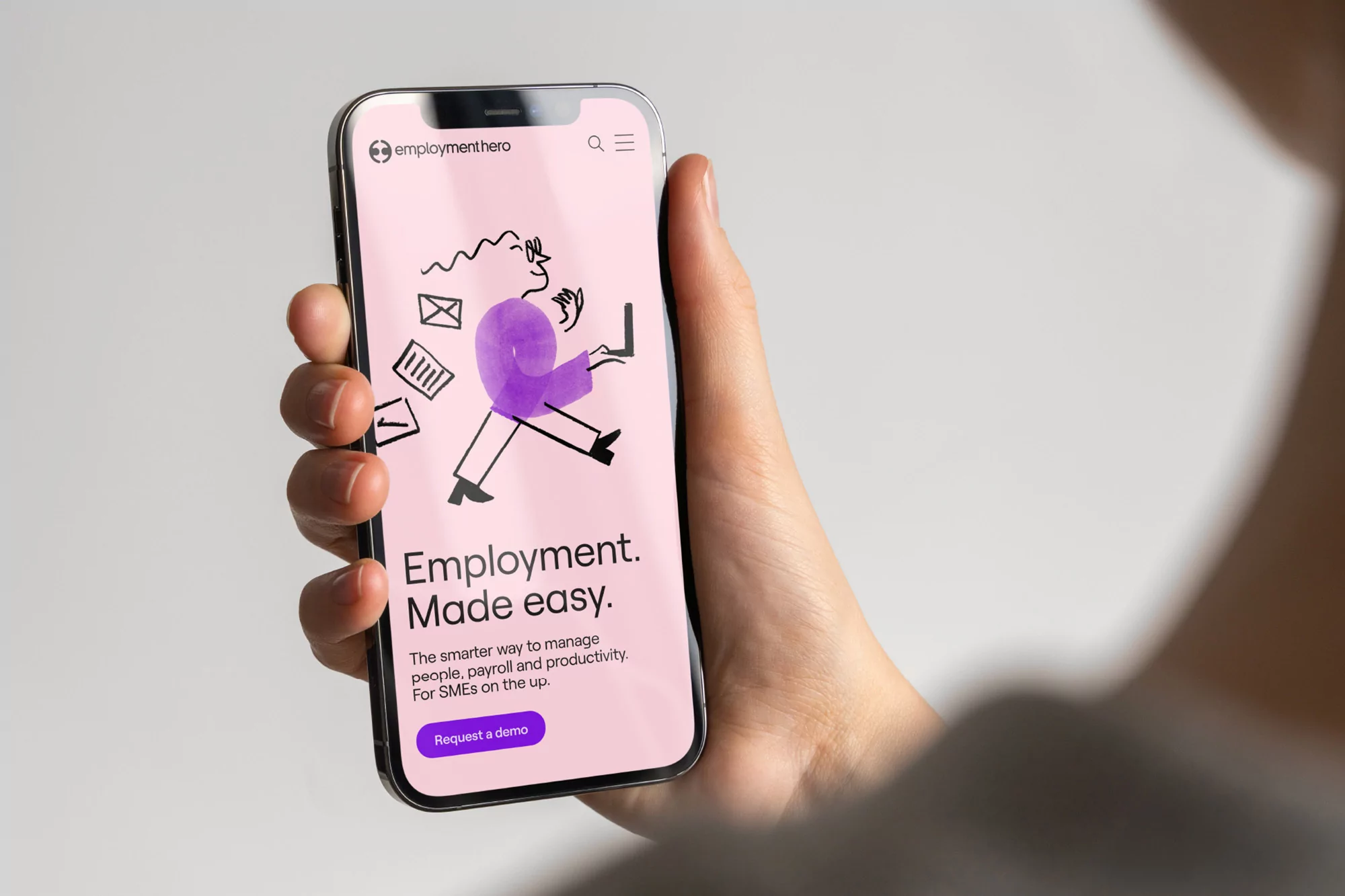 Person holding a smartphone displaying an animated illustration promoting employment management solutions with the company's logo at the top.