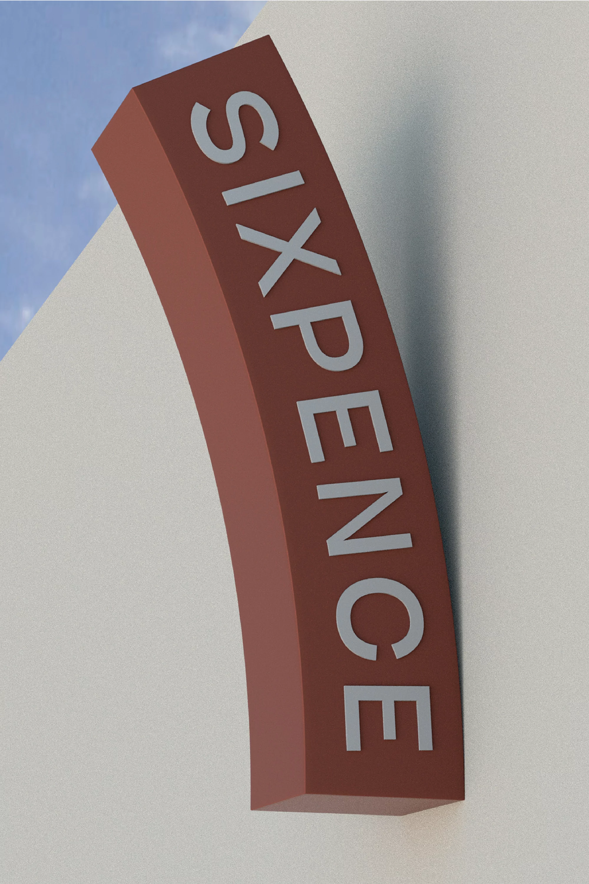 Close-up of a curved, brown sign reading SIXPENCE in silver lettering, attached to a white wall with a glimpse of blue sky.