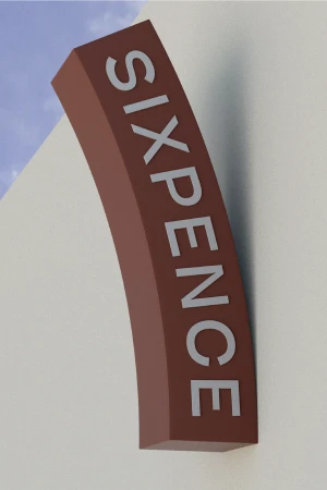 Vertical exterior sign for Sixpence Coffee featuring white lettering on a curved brown structure against an off-white wall and blue sky.