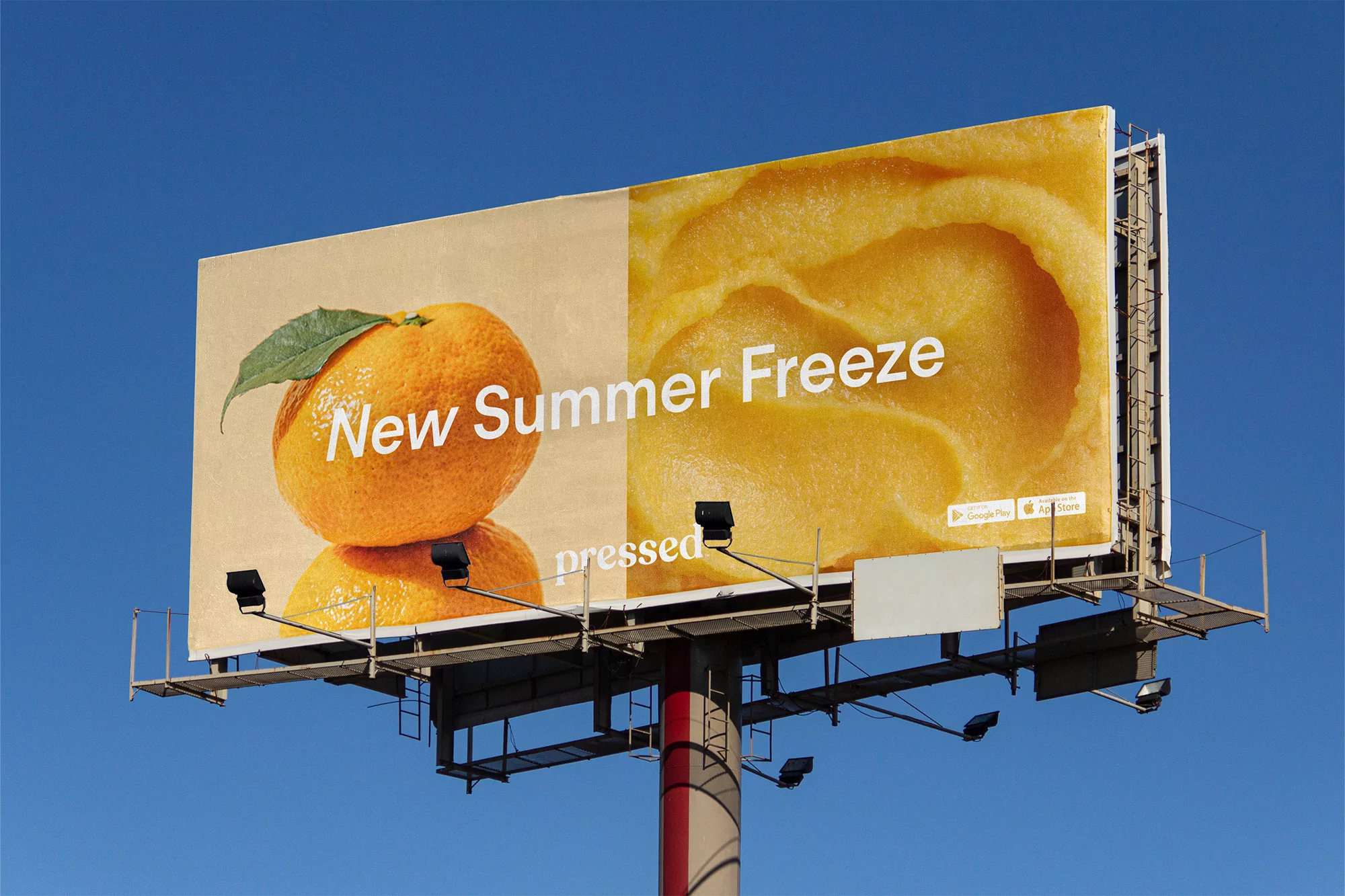 Billboard advertisement featuring citrus fruit and the words 'New Summer Freeze' against a clear blue sky in an outdoor setting.