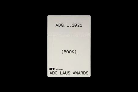 Minimalist white book cover with black typography reading ADG.L.2021 and ADG LAUS AWARDS against a solid black background.