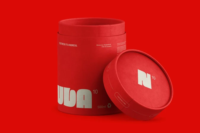 Red cylindrical containers sit against a matching red background, one with an open lid displaying a white stylized logo.