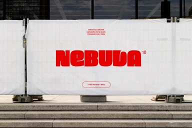 White construction barrier banner displaying bold red Nebula 10 typography mounted outdoors in front of steps.