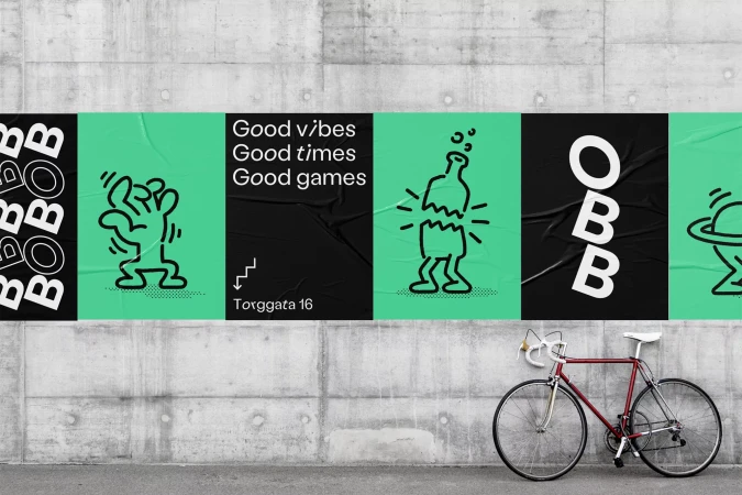 Street art poster on a concrete wall with line drawings and text, along with a red bicycle parked in front of it.