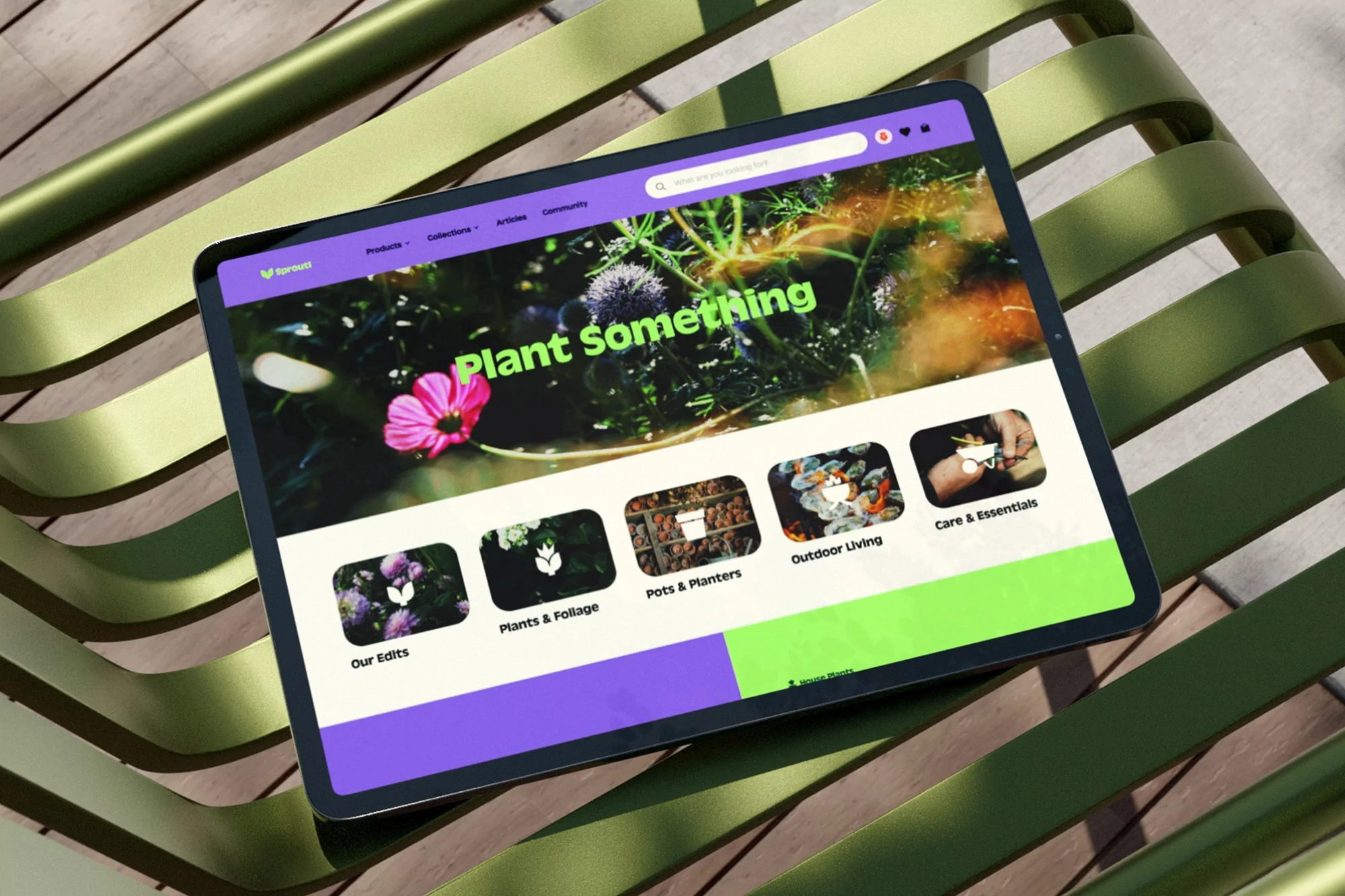 Tablet displaying a gardening website on a green metal bench, showing plants, planters, and greenery in a colorful, inviting layout.