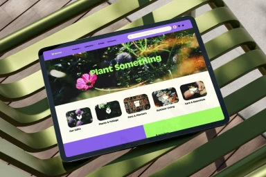 Tablet displaying the Sproutl plant brand website resting on a slatted green metal chair outdoors.