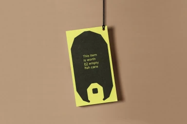 Hanging rectangular price tag with lime green border and central black shape featuring white text against brown paper background.