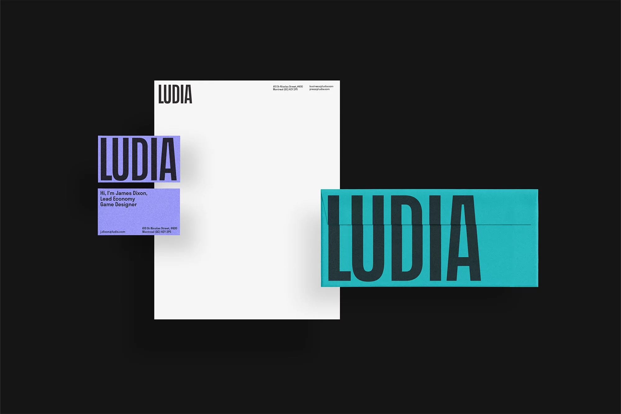 Flat lay of graphic design stationery featuring letterhead, business cards, and branding mockup on a stark black background.