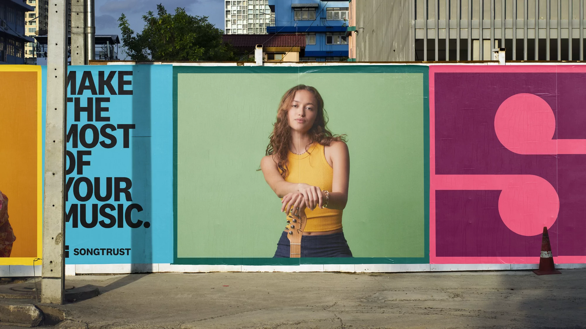 Outdoor billboard advertisement featuring a young woman musician with a guitar, along with the text 'Make the Most of Your Music.'