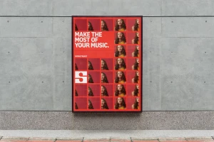 Songtrust brand identity advertising poster mounted on a concrete wall featuring a grid of woman portraits