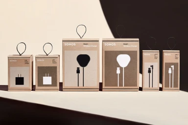 Six Sonos craft paper packaging boxes of varying sizes arranged on a neutral surface with stark shadow angles