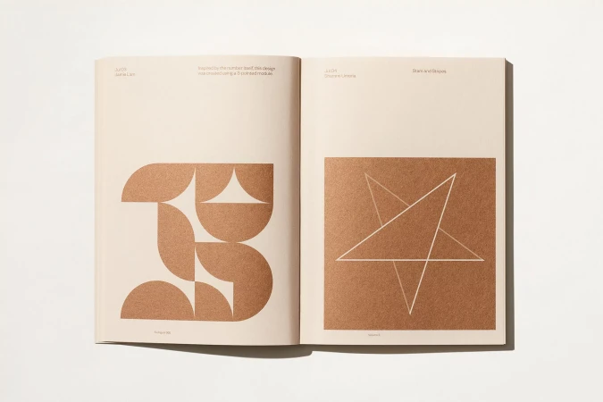 Open book displays geometric designs in copper tones on cream paper, featuring a curved shape and a five-pointed star, viewed from above.