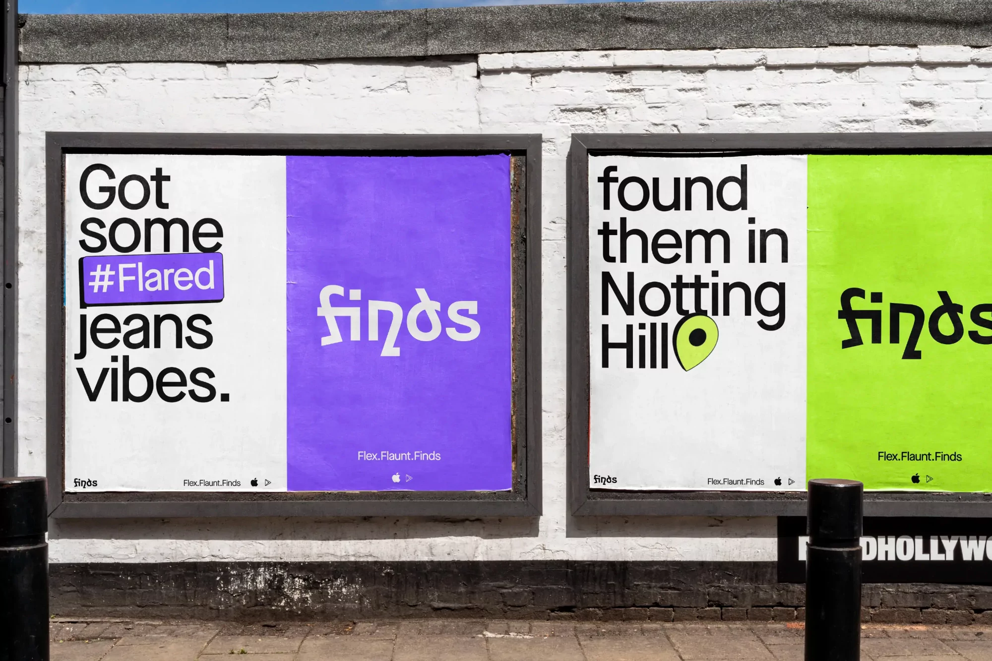 Two vibrant posters on a brick wall advertise 'finds' with bold typography and bright colors, capturing attention on an urban street.