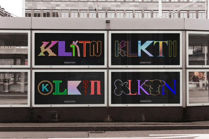 Outdoor advertisement on a bus stop featuring colorful, abstract text designs against a black background on an overcast day.