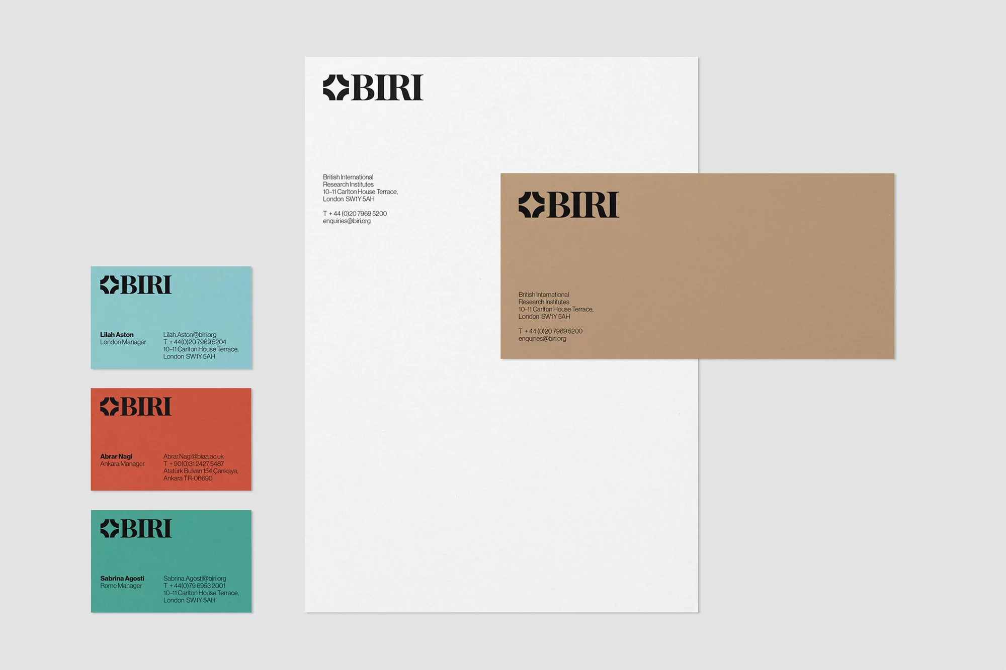 Stationery set features business card, letterhead and envelope with the company logo and contact information on a neutral background.