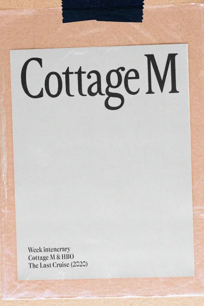 Cottage M brand identity graphic design paper document taped to a brown surface
