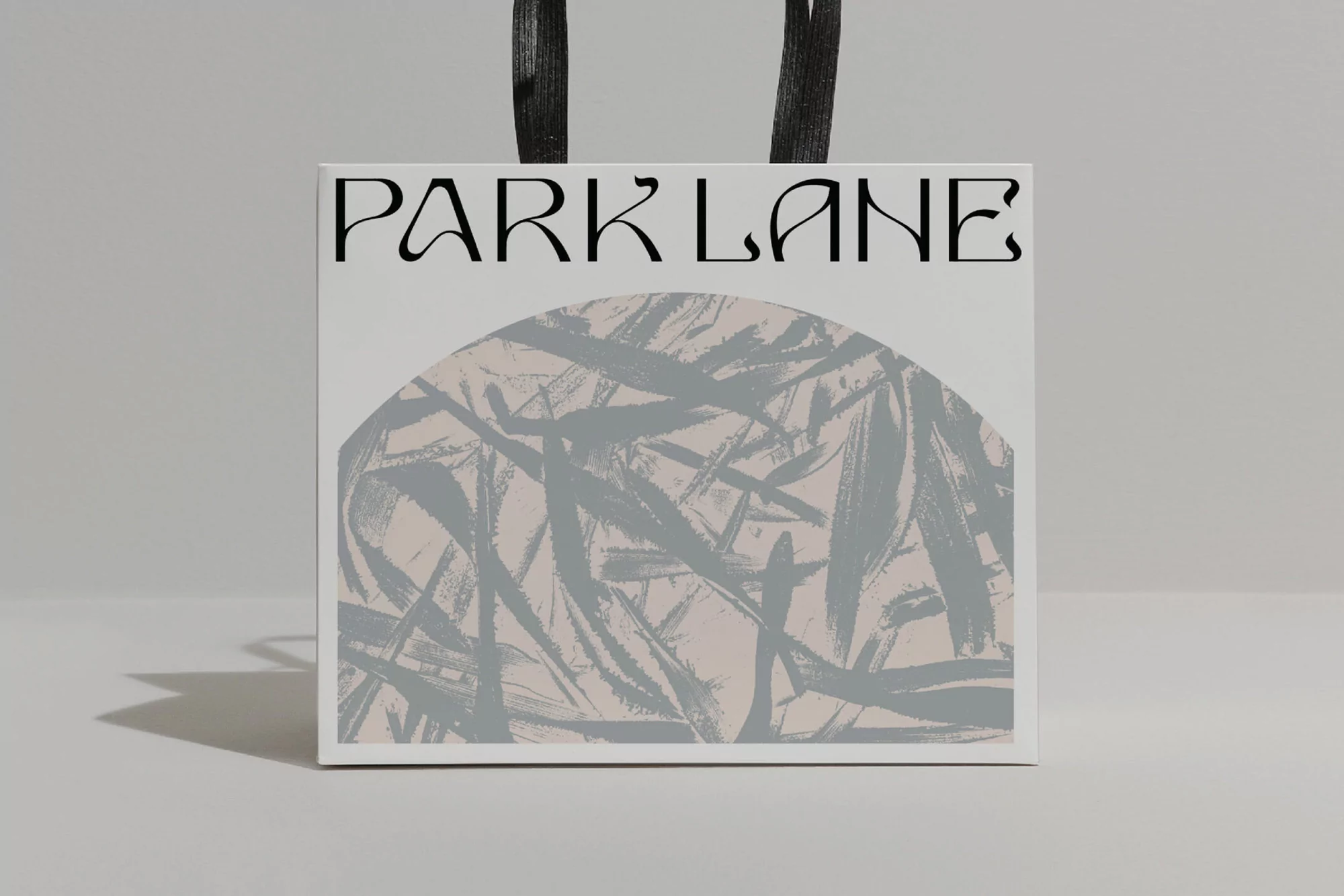 Square shopping bag featuring the logo 'Park Lane' and an abstract grey and beige brushstroke design on a neutral background.
