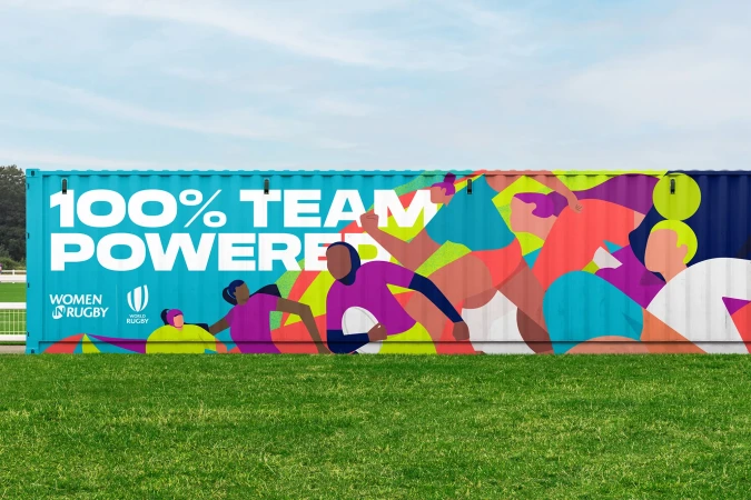 Illustration of female athletes adorns a turquoise container on a green lawn under a blue sky, promoting Women's Rugby and team power.