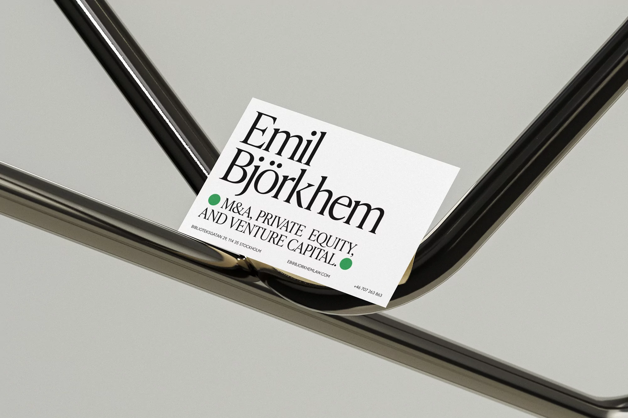 Business card on metal tubing featuring company name, Emil Björkhem, and M&A, Private Equity, and Venture Capital.