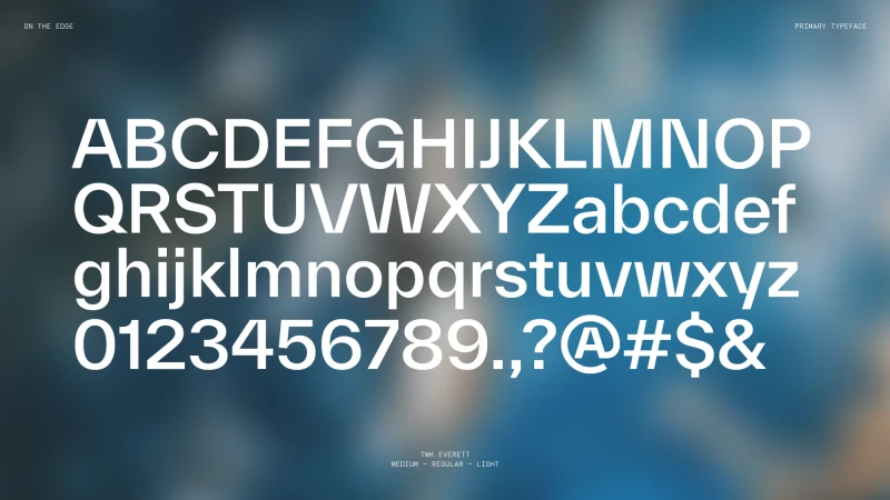 White sans-serif alphabet and numerical characters displayed on a blurred background with the words 'ON THE EDGE' and 'PRIMARY TYPEFACE'.