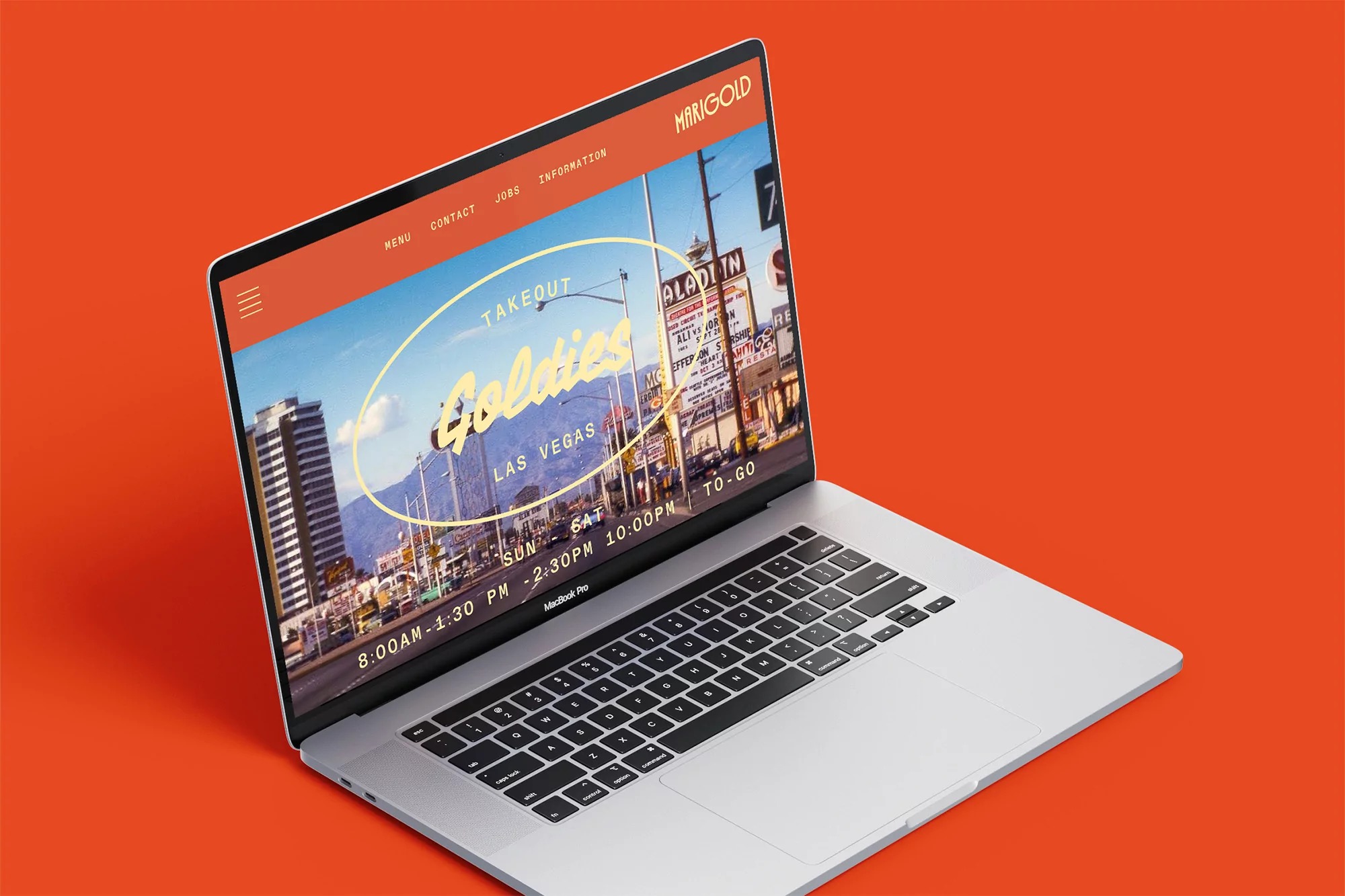 Silver laptop displays the Marigold website with a food menu against an orange background, showcasing Goldies restaurant in Las Vegas.