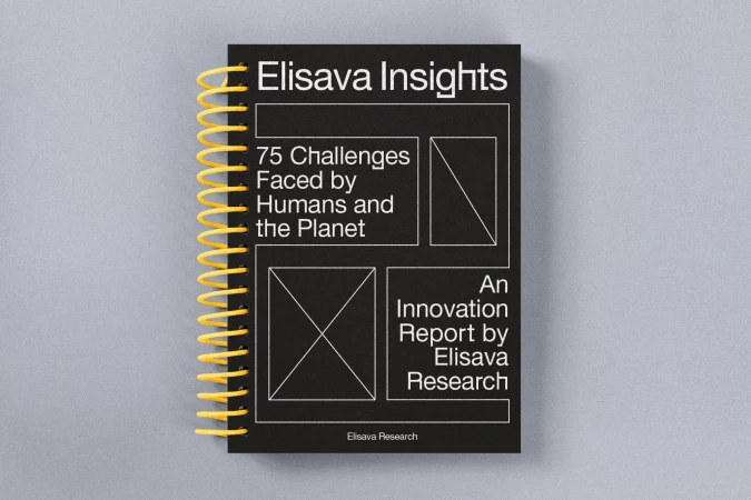 Black cover of the 'Elisava Insights' innovation report with a yellow spiral binding, lying on a light gray surface.