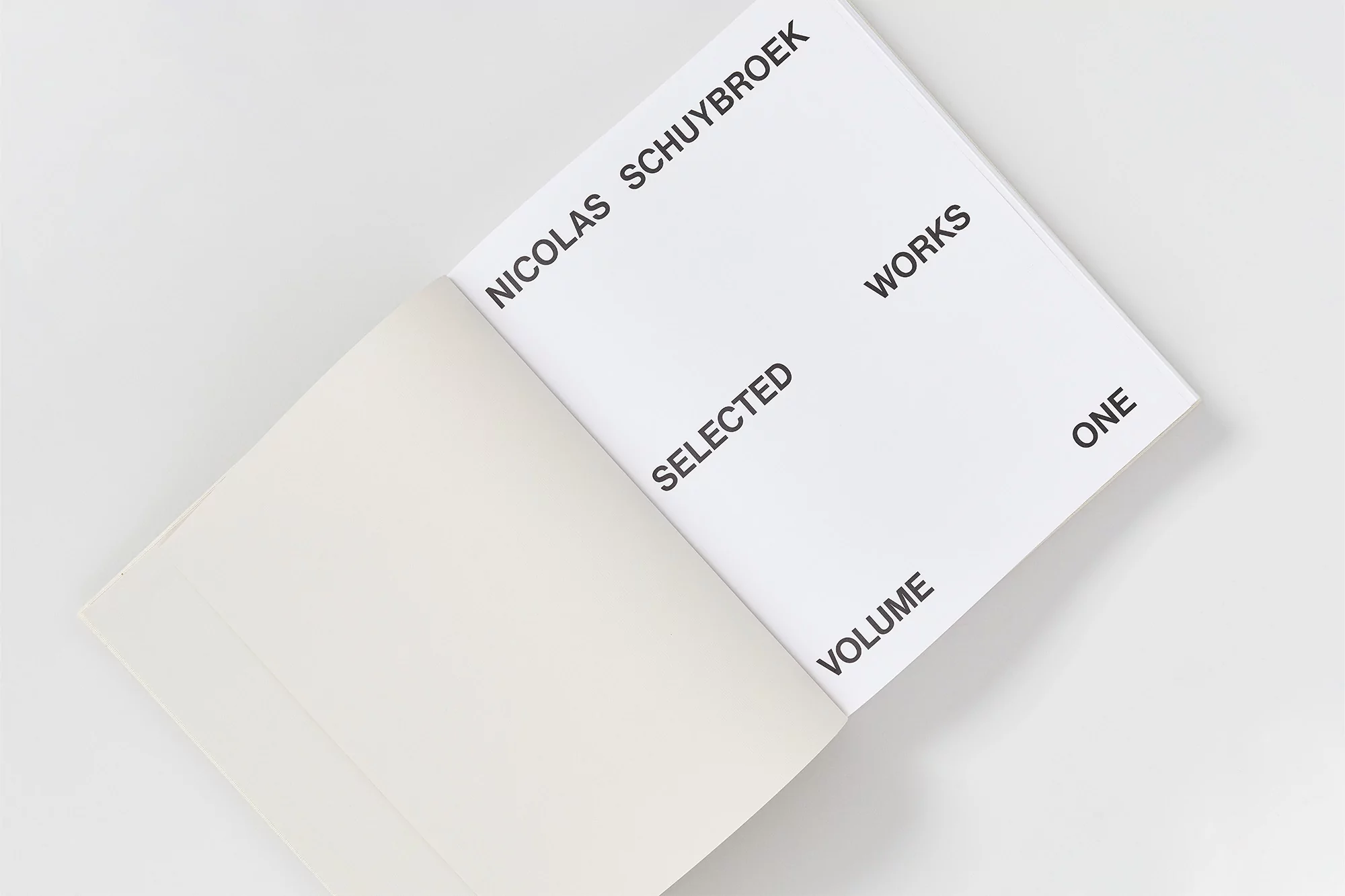 Open book featuring black text on white pages, showing 'Nicolas Schuybroek Works Selected Volume One' on right-hand page.