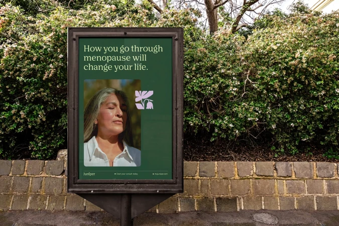 Billboard ad featuring an older woman with graying hair on a green background, surrounded by greenery. Advertising the company Juniper.