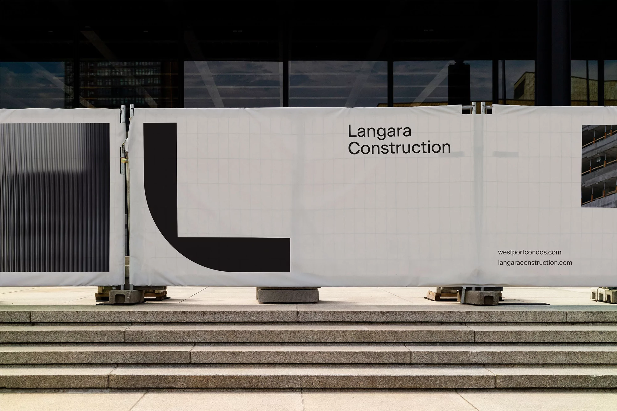 Langara Construction sign on a building site, featuring the company logo, website addresses, and an image of a building.