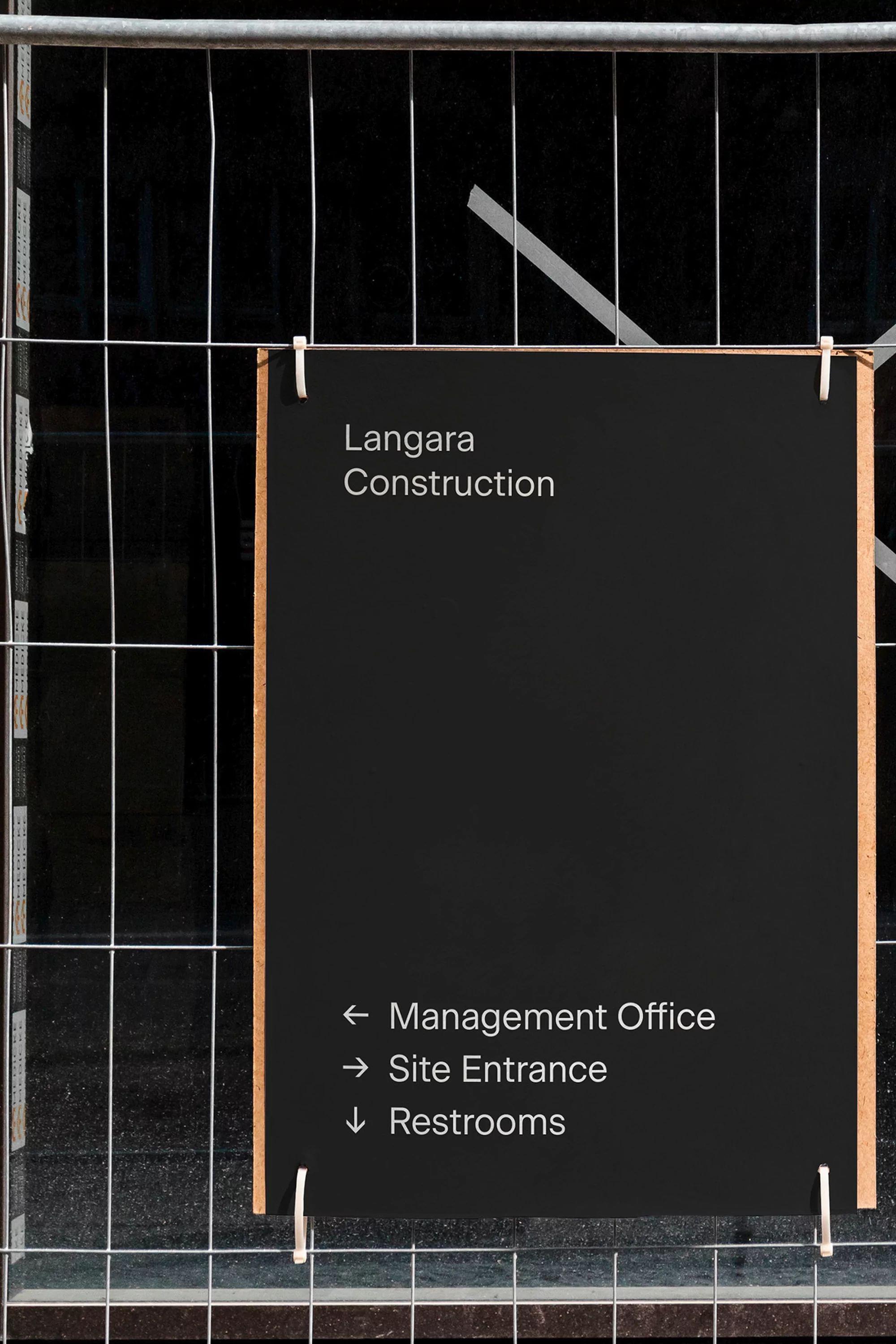 Directional sign for Langara Construction with arrows pointing to Management Office, Site Entrance, and Restrooms.