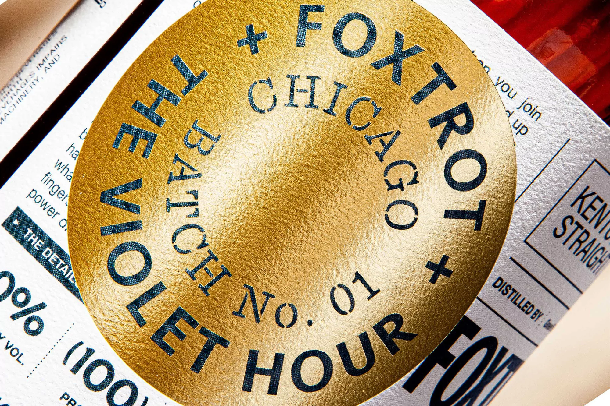 Close-up of Foxtrot Chicago's The Violet Hour Batch No. 01 bottle with a gold label.