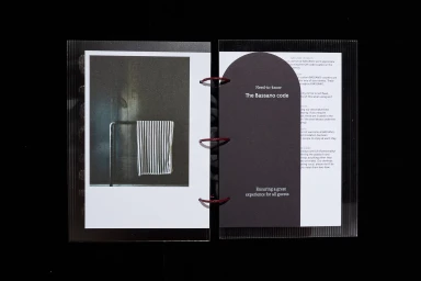 Open ring-bound booklet featuring a photograph on the left and an arched dark card insert on the right with typographic details